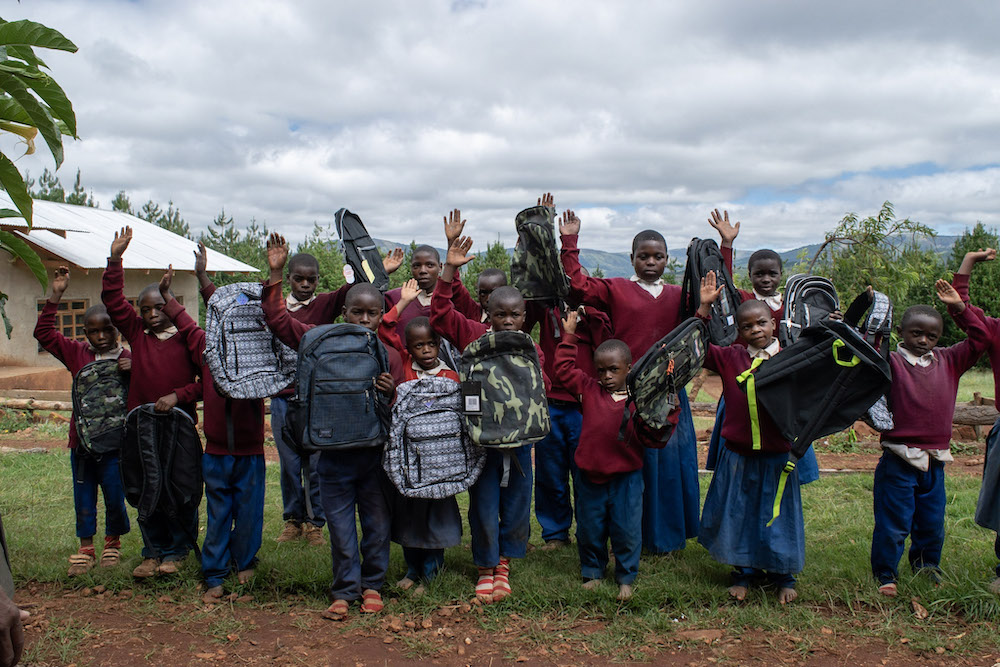 Kids in Wangama getting donated backpacks
