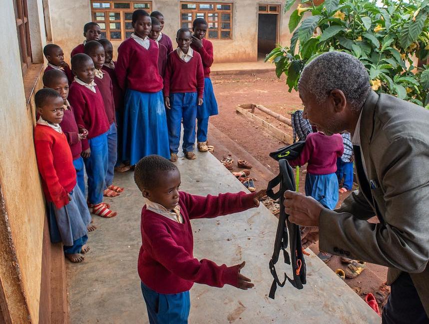 children getting donated backpacks